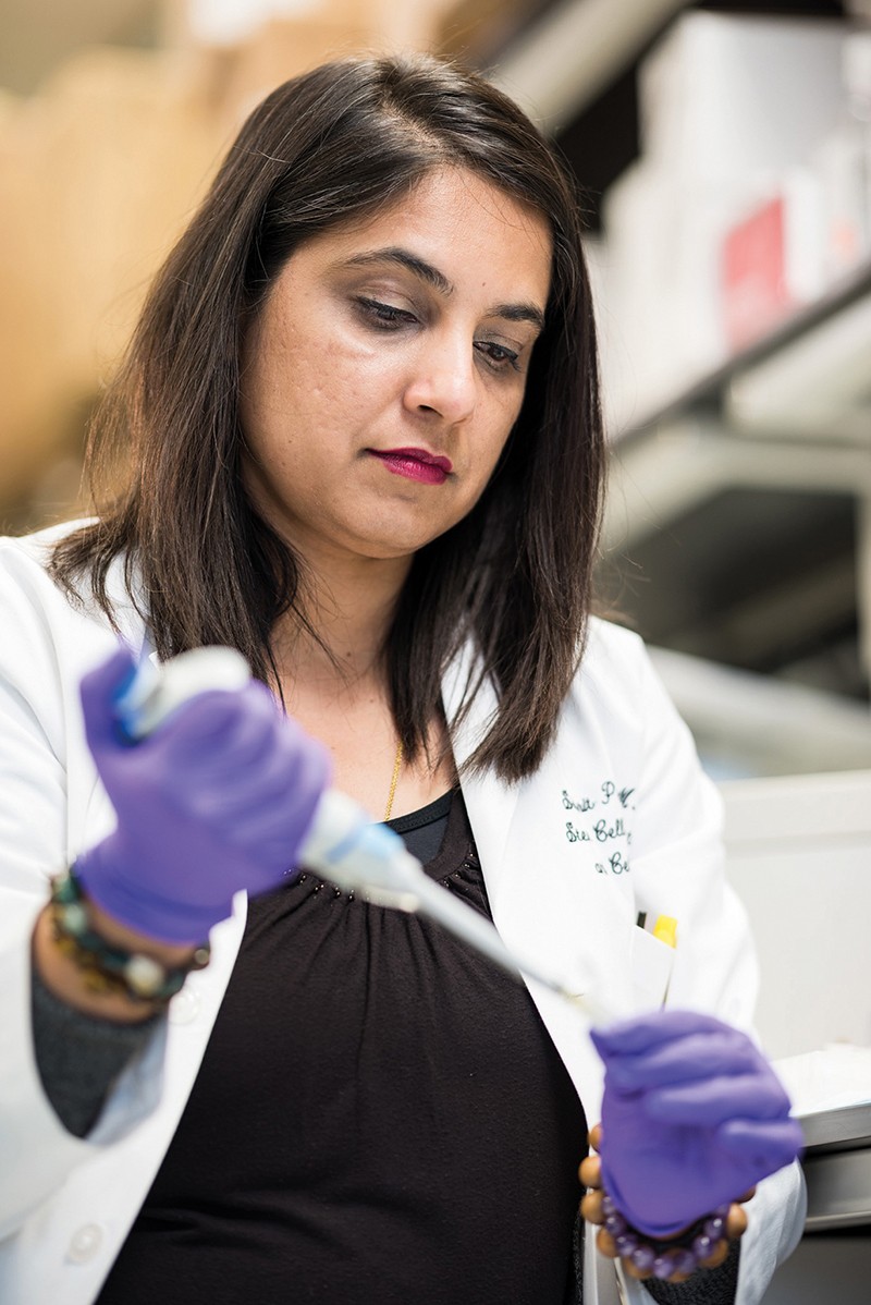 Dr. Simrit Parmar pipetting in her laboratory at MD Anderson Cancer Center